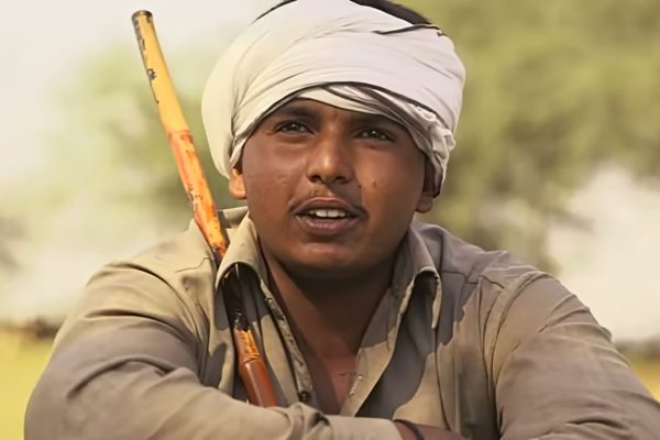 a worried farmer is sitting on the ground