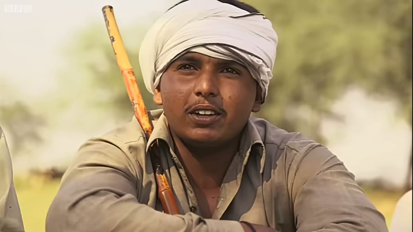 a worried farmer is sitting on the ground